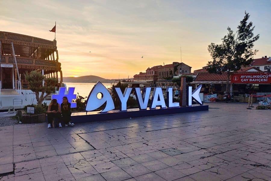 sign ayvalik harbor sunset turkey