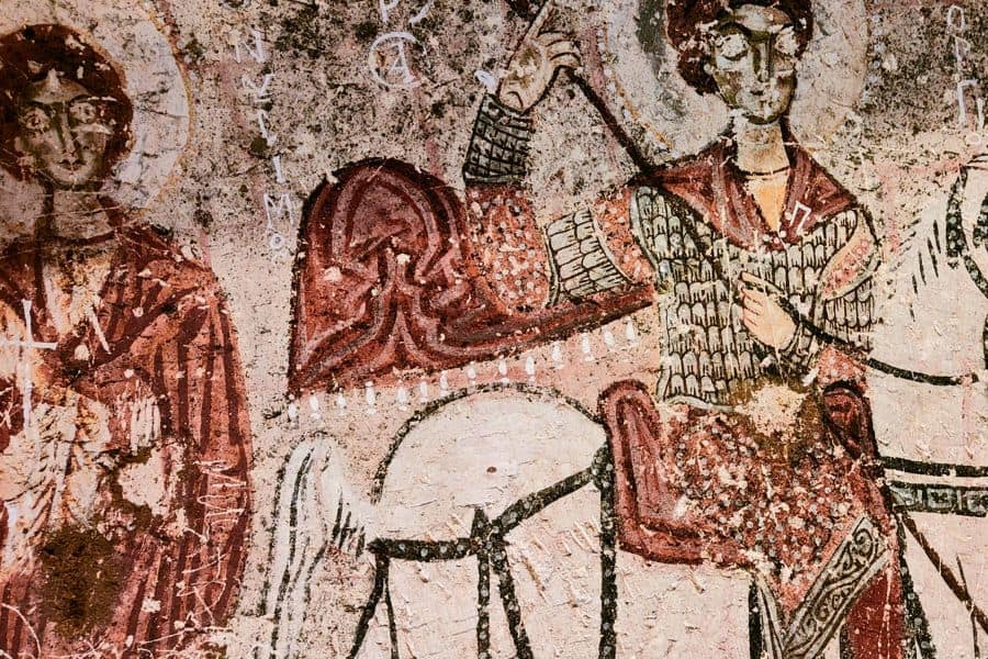 elaborate paintings depicting saints Onesimus, George, and Theodore figures in snake church in goreme open air museum