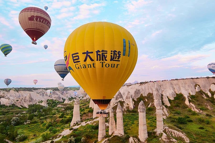 hot air balloon literally touching the fairy chimneys at love valley cappadocia