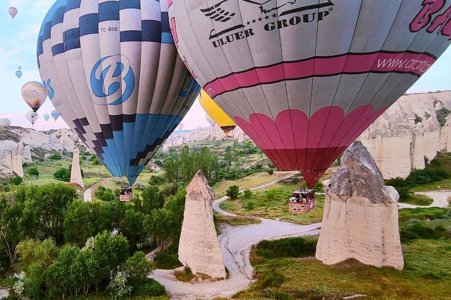 hot air balloons so close to each other almost touching while a ride over love valley in cappadocia
