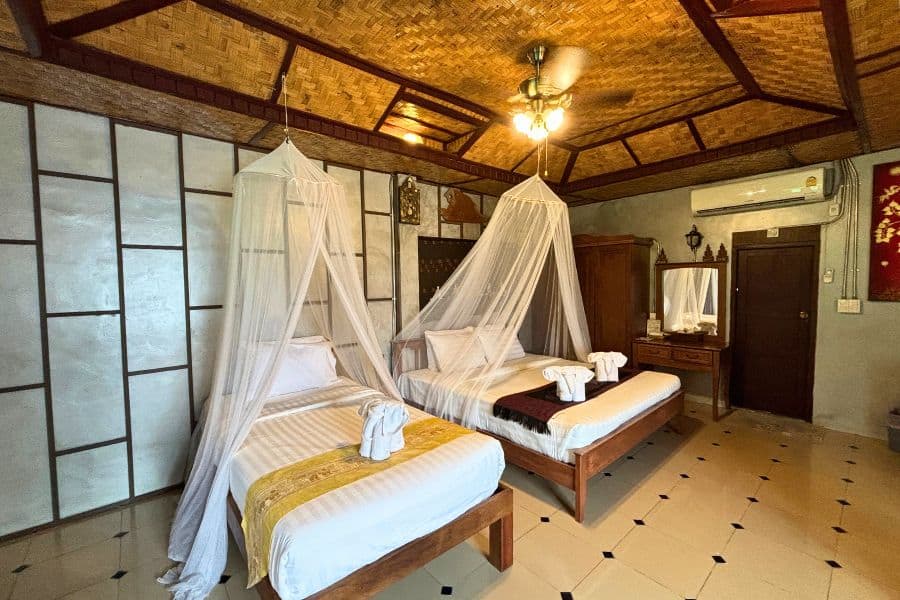 singnature villa family room featuring a double bed and a single bed at buri gallery house resort in chiang mai