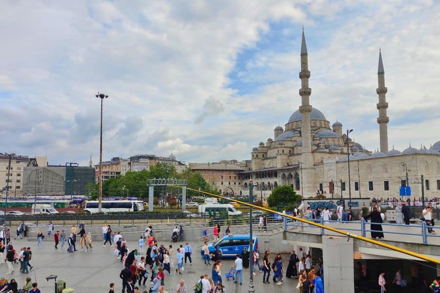 eminonu square in istanbul bustling with people and the new mosque aka yeni camii in the background
