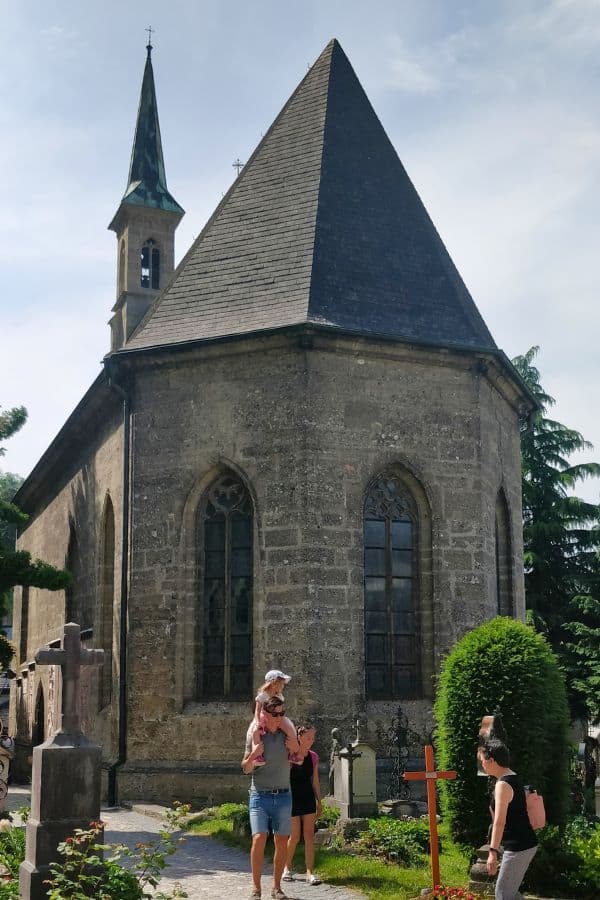 tourists exploring margarethenkapelle aka margarets chapel in the petersfriedhof aka st. peters cemetery salzburg