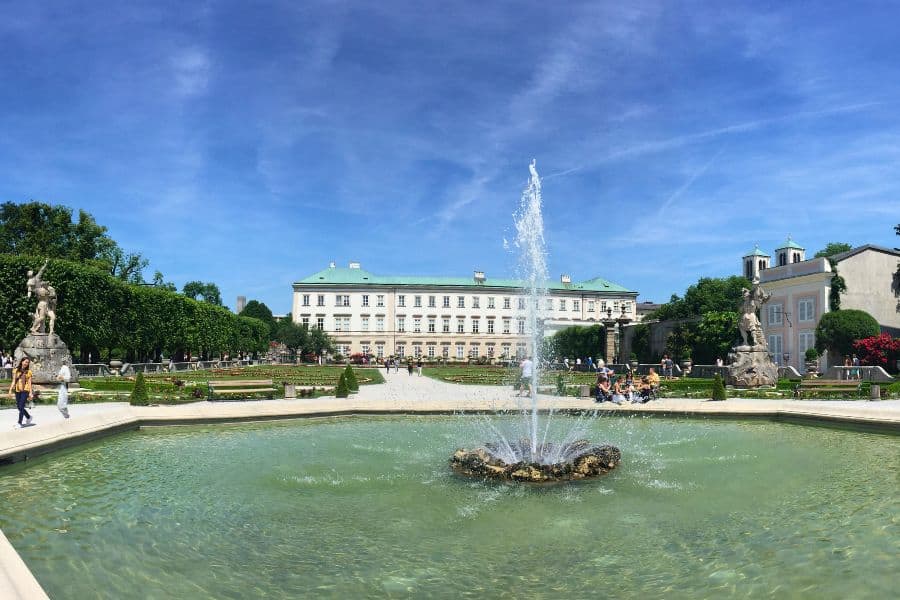 mirabell palace and garden with a fountain in the middle