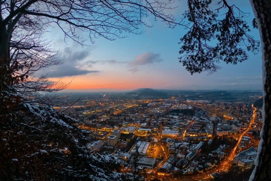 salzburg city all lit up as seen from the mountain kapuzinerberg