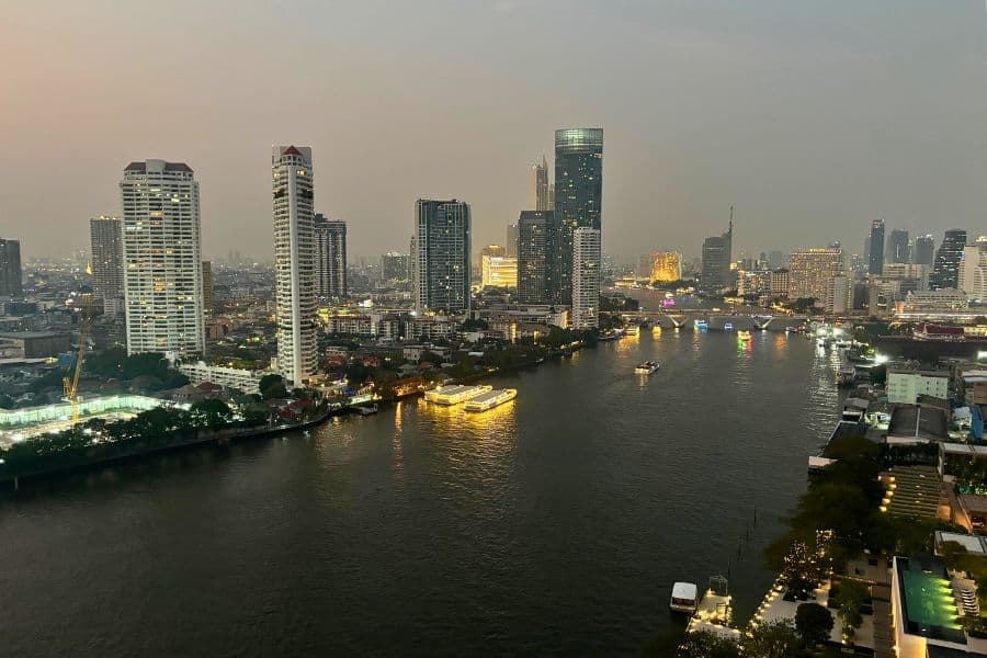 evening view of bangkok skyline with the chao phraya river and illuminated buildings from chatrium riverside hotel in bangkok