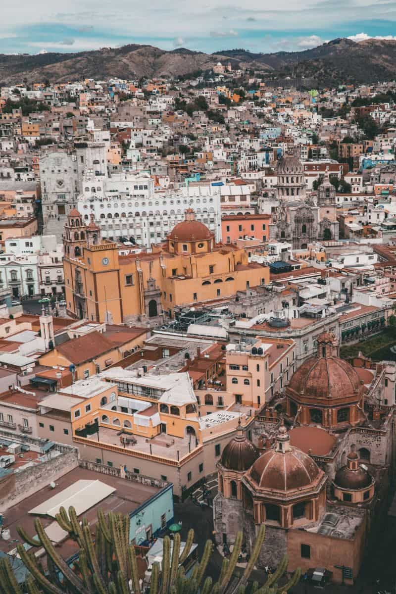 aerial view of guanajuato, mexico, featuring colorful colonial buildings and historic churches nestled within a mountainous landscape