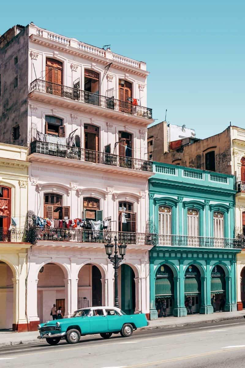  colorful colonial buildings and vintage car in havana cuba