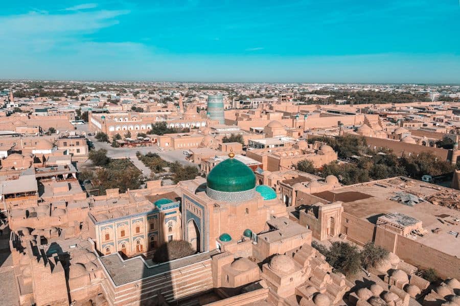 aerial view of itchan kala khiva from islam khoja minaret with pakhlavan mahmud mausoleum green dome and historic mud brick city