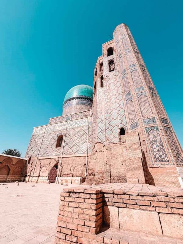 bibi khanym mosque minaret and turquoise dome under clear blue sky samarkand