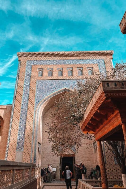 courtyard of pakhlavan mahmud mausoleum khiva with tiled iwan and carved wooden pillars