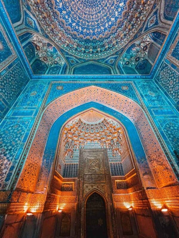 ornate interior of tilya-kori madrasah with gilded ceiling and blue tilework at registan