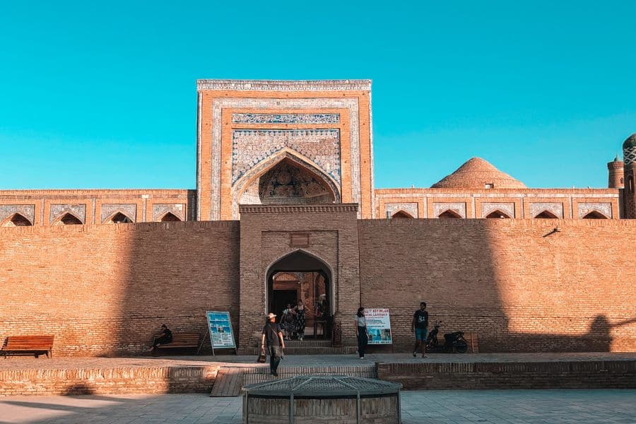 entrance of muhammad rahim khan madrasa in itchan kala khiva with tiled portal and brick walls