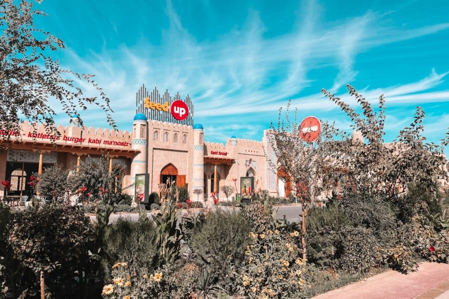 feedup restaurant in khiva with traditional style facade blue domes and landscaped garden in front
