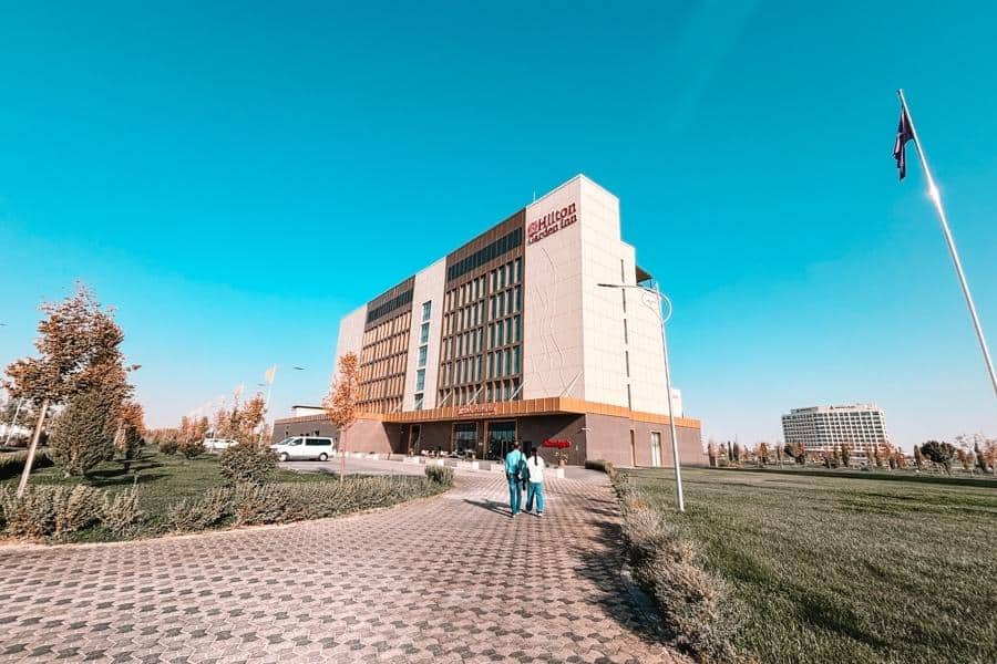 hilton garden inn samarkand afrosiyob hotel exterior in samarkand with clear blue sky and walkway leading to entrance