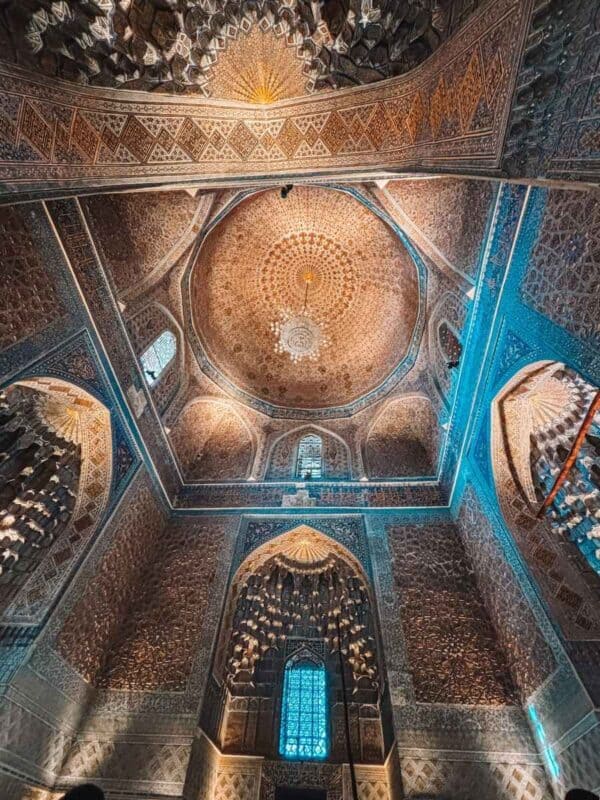 ornate dome interior with chandeliers inside gur-e-amir mausoleum