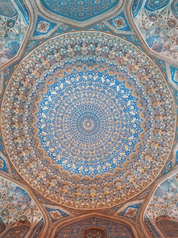 ornate painted ceiling of tilya-kori madrasah mosque with blue and gold floral patterns at registan square