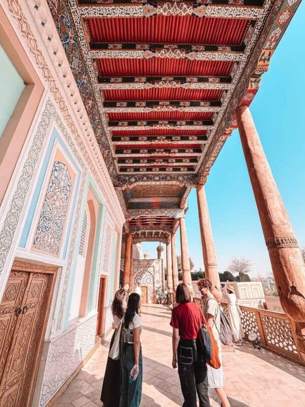 painted wooden ayvan ceiling with carved columns at hazrat khizr mosque