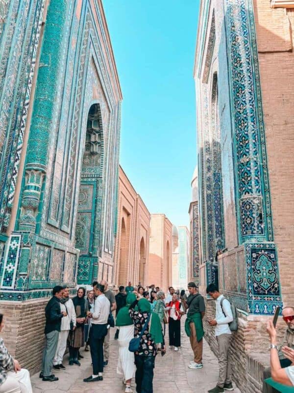 narrow passage between turquoise tiled mausoleums at shakhi zinda samarkand