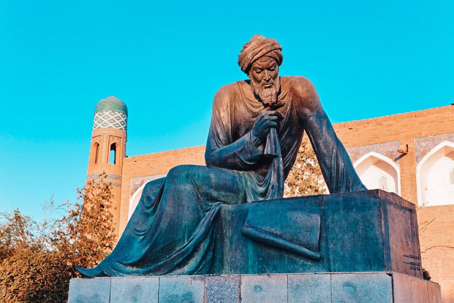 statue of muhammad al khwarizmi in khiva with historic architecture in background