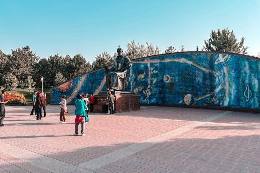 statue of ulugh beg at the observatory complex with celestial mosaic mural in samarkand