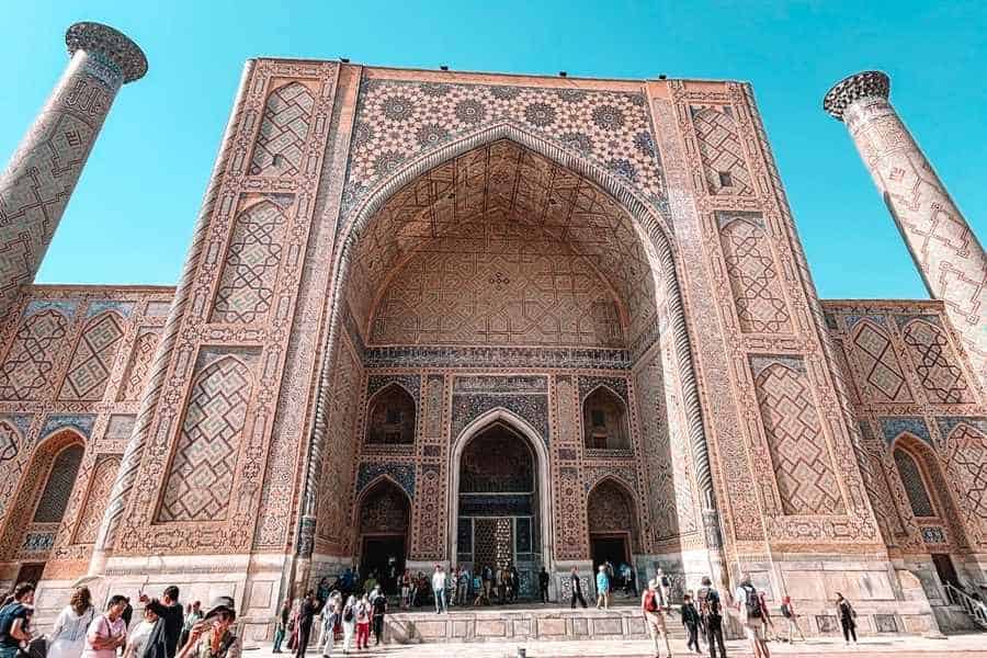 ulugh beg madrasah entrance at registan square in samarkand with tall tiled iwan and twin minarets