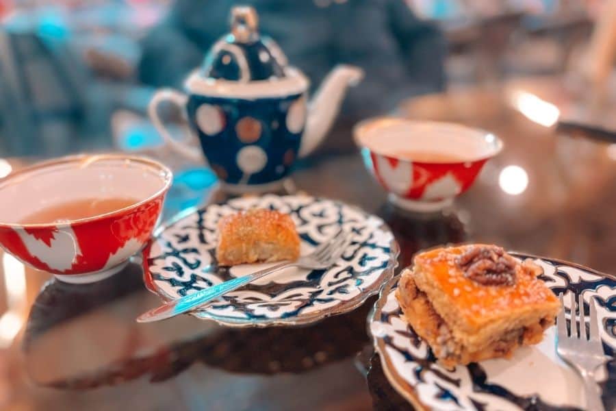uzbek tea served with baklava on traditional blue and white ceramic plates