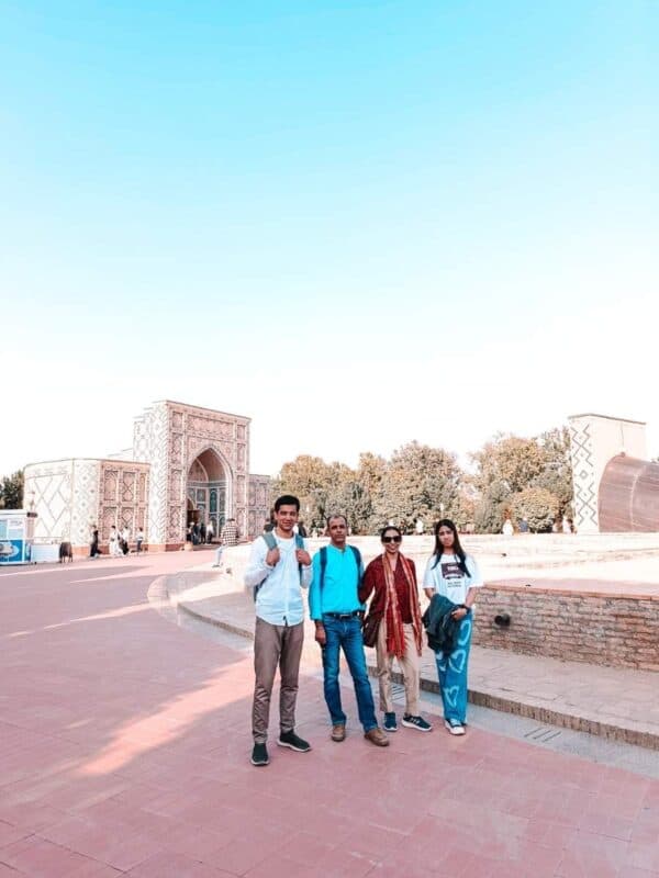 we posing with our tour guide at ulugh beg observatory complex samarkand