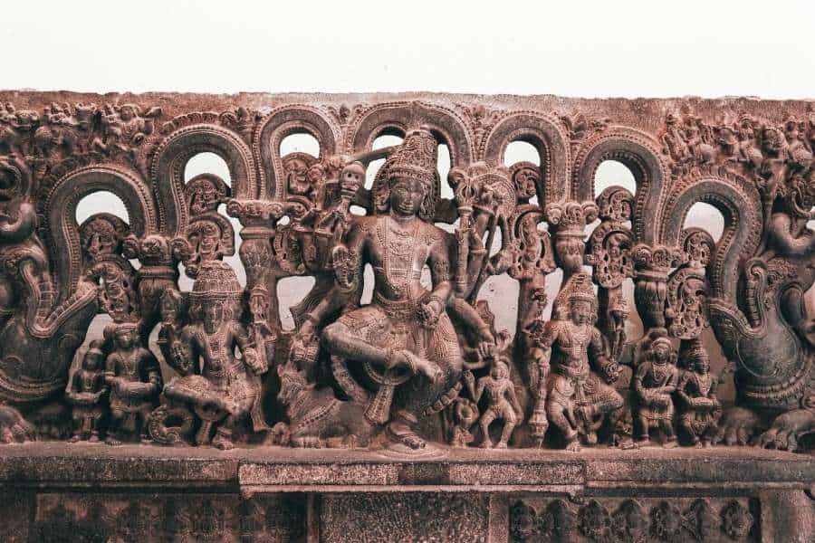 ancient stone carving depicting hindu deities surrounded by divine figures and elaborate naga motifs, national museum delhi
