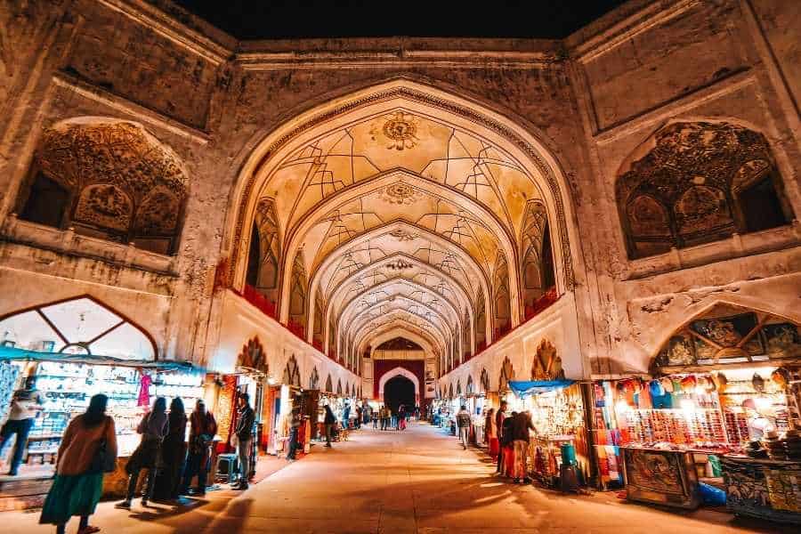 chhatta chowk bazaar inside red fort, lit up at night with arched ceilings and souvenir shops on both sides