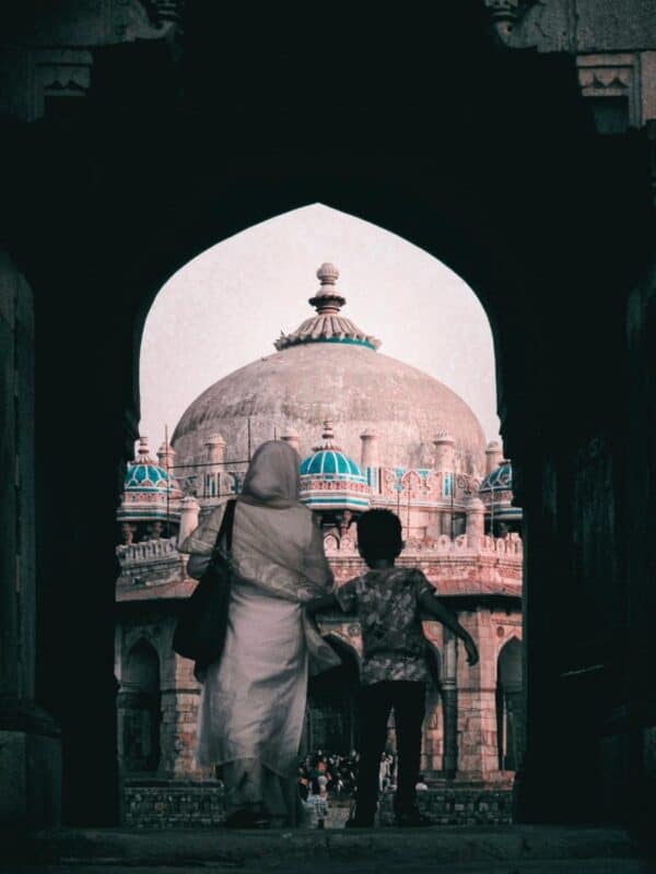 a woman and child walking toward isa khan’s tomb inside humayun’s tomb complex in delhi