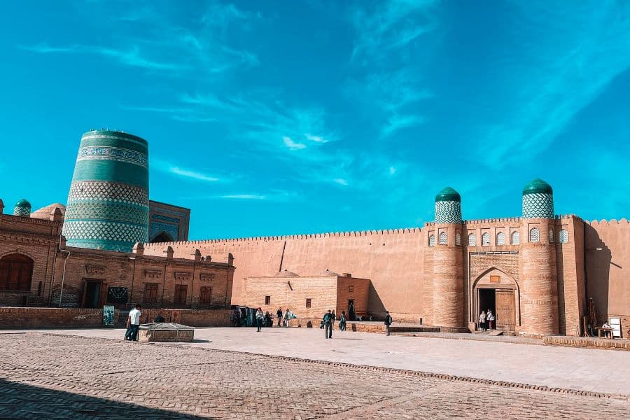 kalta minor minaret with the kuhna ark gate and fortress walls inside itchan kala, khiva