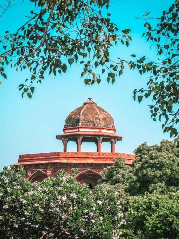 octagonal pavilion at purana qila framed by lush greenery
