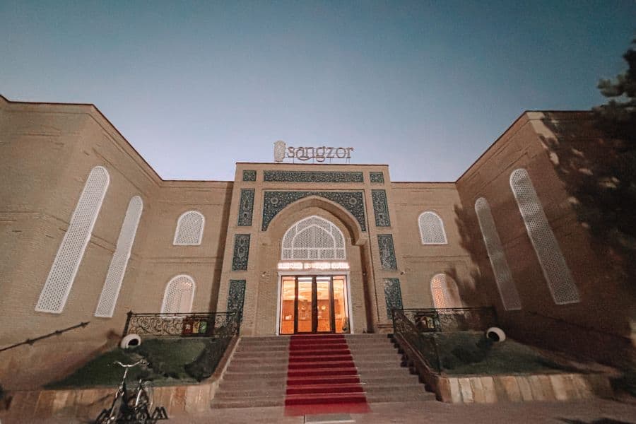 sangzor boutique hotel exterior in samarkand with arched entrance and evening lighting