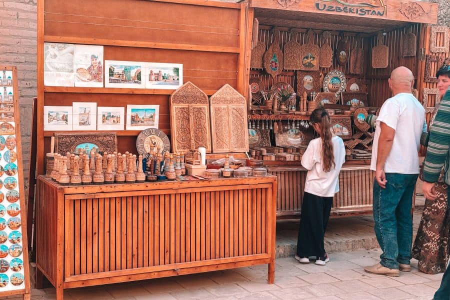 handmade wooden souvenirs and carved boxes at a small craft stall inside itchan kala old town, khiva