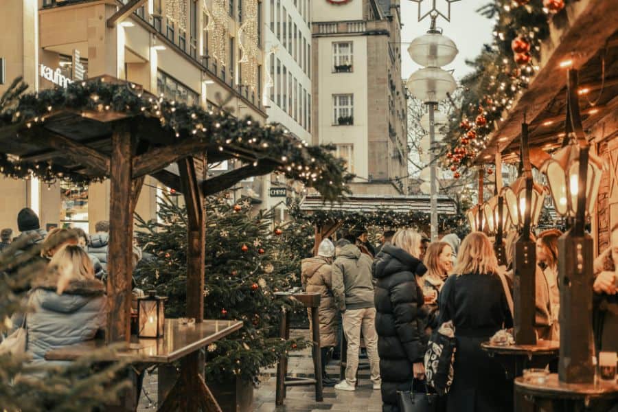 christmas market in european city with wooden stalls and holiday lights