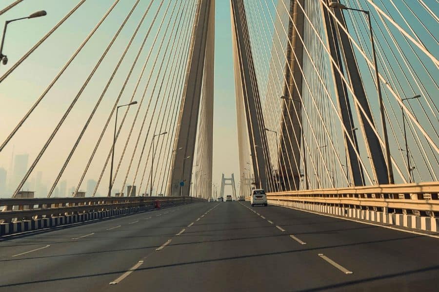 Driving across the Bandra-Worli Sea Link in Mumbai, viewed from inside a car with the cable-stayed bridge's pylons and cables rising overhead