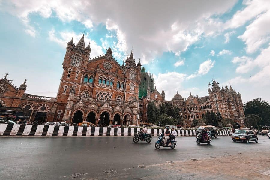 Chhatrapati Shivaji Maharaj Terminus (CST), the UNESCO World Heritage railway station in Fort, South Mumbai, with morning traffic on the road in front