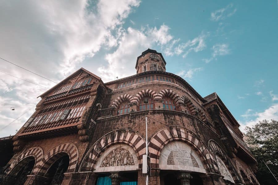 The Norman Gothic facade of Crawford Market (Mahatma Jyotiba Phule Mandai), built in 1869, in Fort, South Mumbai, featuring the Lockwood Kipling bas-relief sculptures and the building's distinctive striped stone arches