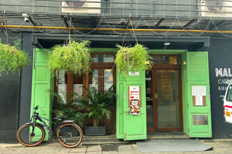 The green-doored entrance of Malido Cafe in the Kala Ghoda art district, Fort, South Mumbai