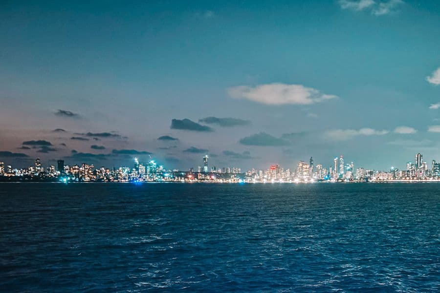 The Mumbai skyline at night, lit up across the Arabian Sea — the famous "Queen's Necklace" view from Marine Drive